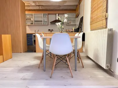 two beds in a small room with a window at Duplex in Gracia in Barcelona