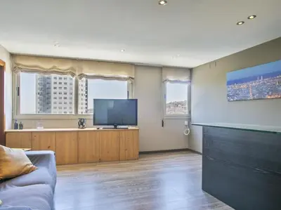 a bathroom with a sink and a clock on the wall at Apartamento temporal en Barcelona in Barcelona