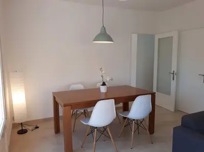 a dining room table and white chairs in a room at Alt Penedes, terra de vinya, sol, aigua i muntanya in Torrellas de Foix
