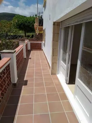 a tiled walkway next to a building at Alt Penedes, terra de vinya, sol, aigua i muntanya in Torrellas de Foix
