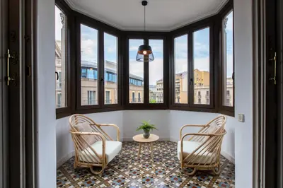 two chairs in a room with windows at B41 - Apartamento para grandes grupos en BCN centro in Barcelona