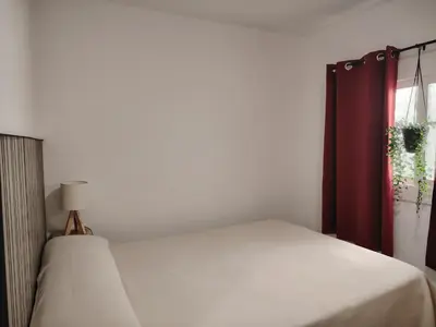 a bedroom with a bed and a window at Apartamento centrico en Calella in Calella