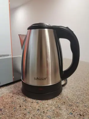 a silver and black tea kettle on a counter at Apartamento centrico en Calella in Calella