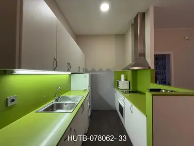 a kitchen with green and white counters and a sink at Palau de la música 2 in Barcelona