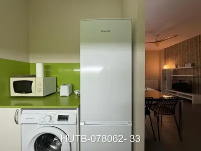 a kitchen with a white refrigerator and a microwave at Palau de la música 2 in Barcelona