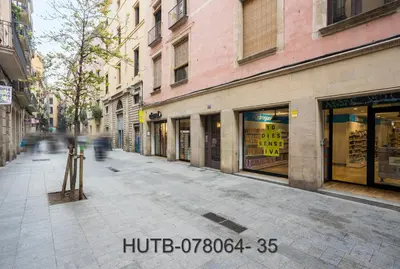 an empty city street with shops and buildings at Palau de la música 4 in Barcelona