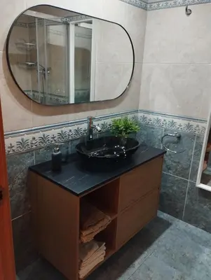a bathroom with a black sink and a mirror at Stylish Duplex Loft with terrace in Barcelona