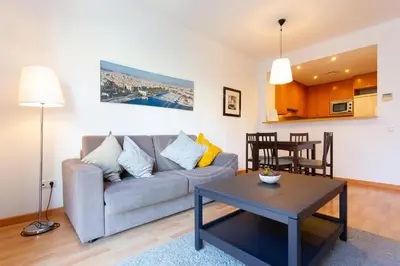 a living room with a couch and a table at Cosy Apartment next to Sagrada Familia V in Barcelona