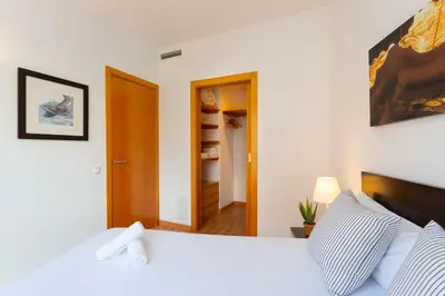 a living room with a mirror and a room with a bed at Cosy Apartment next to Sagrada Familia V in Barcelona