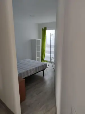 a living room with a bench and a window at Apartment 3 minutes from the beach and train station on foot in Canet de Mar