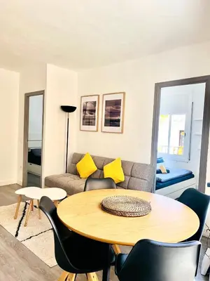 a living room with a table and a couch at Have Fun Apartment in Cubelles in Cubelles