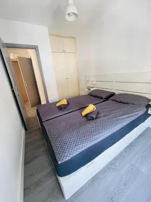 a bedroom with a bed with two yellow pillows on it at Have Fun Apartment in Cubelles in Cubelles