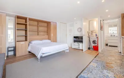 a bedroom with a white bed and a television at Amazing Apartment In Sant Pere De Ribes in Sant Pere de Ribes