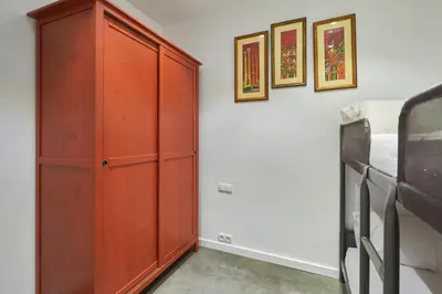 a bedroom with a red cabinet next to a bed at 64 Apartment in a typical Barcelona's old building in Barcelona