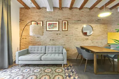 a living room with a couch and a table at 64 Apartment in a typical Barcelona's old building in Barcelona