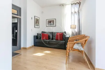 a white kitchen with a washer and dryer at Cosy apartment with terrace in Barcelona