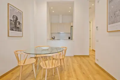 a dining room with a glass table and chairs at Aspasios Arc de Triomf Apartments in Barcelona
