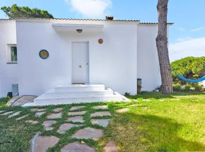 a white house with a white door and stairs at Casa Blanca in Sant Cebrià de Vallalta