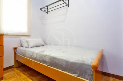 a small bed in a room with a window at Huge Sagrada Familia in Barcelona