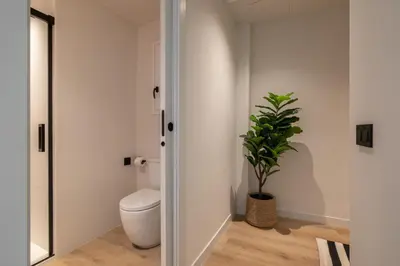 a bathroom with a toilet and a potted plant at Stay U-nique Apartment Corsega II in Barcelona
