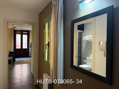 a mirror on a wall next to a bathroom at Palau de la música 5 in Barcelona