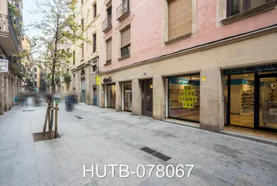 an empty city street with shops and buildings at Palau de la música 7 in Barcelona