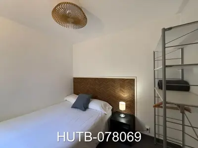 a bedroom with a bed and a lamp and a shelf at Palau de la música 9 in Barcelona