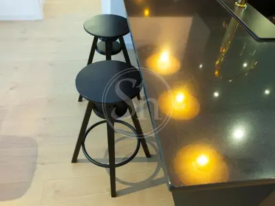 a black stool sitting next to a glass table at Agradable y luminoso apartamento ideal para 5 in Barcelona