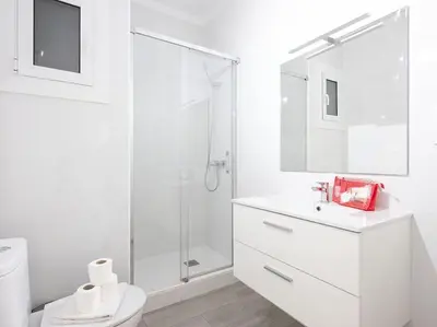 a white kitchen with a sink and a microwave at Alcam Baro in Barcelona