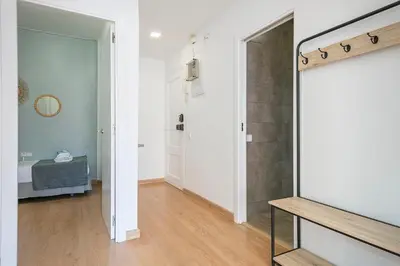 a bedroom with a bed and a table with towels at Alcam Baro in Barcelona