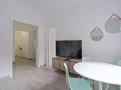 a living room with a couch and a table and chairs at Alcam Baro in Barcelona