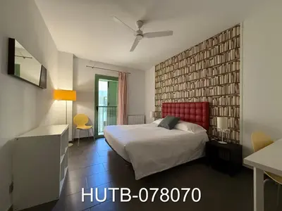 a bedroom with a large bed with a red headboard at Palau de la música 10 in Barcelona
