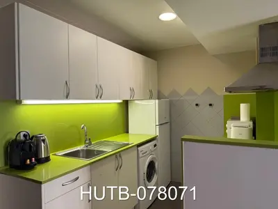 a kitchen with green and white cabinets and a sink at Palau de la música 11 in Barcelona
