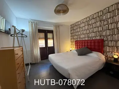 a bedroom with a large bed with a red headboard at Palau de la música 12 in Barcelona
