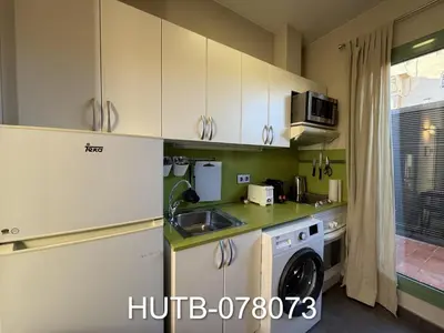 a kitchen with a sink and a washing machine at Palau de la música 13 in Barcelona