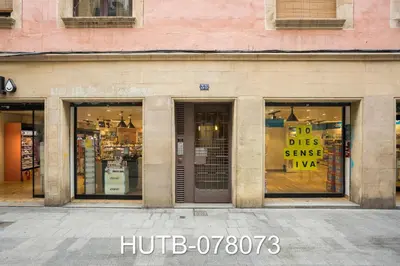 a store front with signs in the windows at Palau de la música 13 in Barcelona