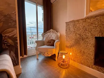 a park with benches and buildings on a city street at Spacious Penthouse with big private terrace & view in Barcelona