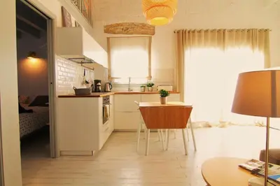a small kitchen with a table and a dining room at Mediterrani Vacaciones perfectas y vistas al mar in Sitges