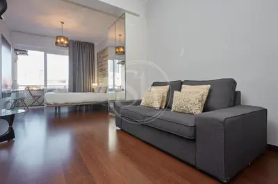 a living room with a couch and a table at Moderno Estudio en Eixample in Barcelona