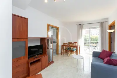 a living room with a blue couch and a television at Apartamento para 3 con balcón in Barcelona