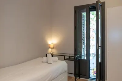 a bedroom with a bed and a window at Ola Living Gracia in Barcelona