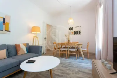 a living room with a couch and a table at Apartamento cerca de Sagrada Familia in Barcelona