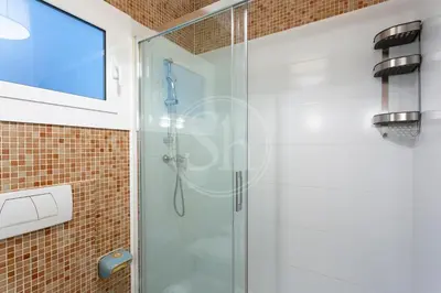 a shower with a glass door in a bathroom at Cómodo piso en Eixample in Barcelona