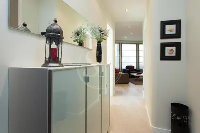 a living room with a glass counter and a staircase at Apartamento familiar en Avenida Gaudí in Barcelona