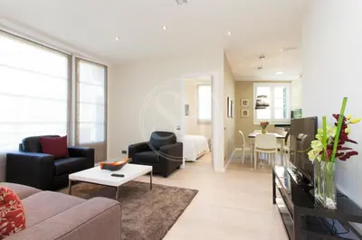 a living room with a couch and a table at Apartamento familiar en Avenida Gaudí in Barcelona