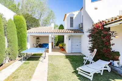 a backyard with a ping pong table and chairs at Villa Romady in Sant Pere de Ribes