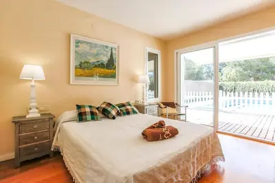 a bedroom with a bed with a purse on it at Villa Romady in Sant Pere de Ribes