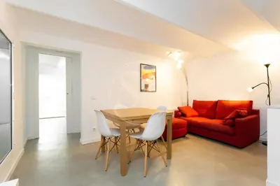 a living room with a table and a red couch at Apartamento en Villaroel 2 in Barcelona