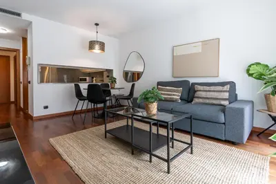 a living room with a blue couch and a table at Lovely apartment Sagrada Familia in Barcelona