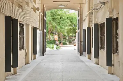 an alley between two buildings with an archway at Jaiz - 2 bedrooms and terrace in Eixample Esquerra in Barcelona